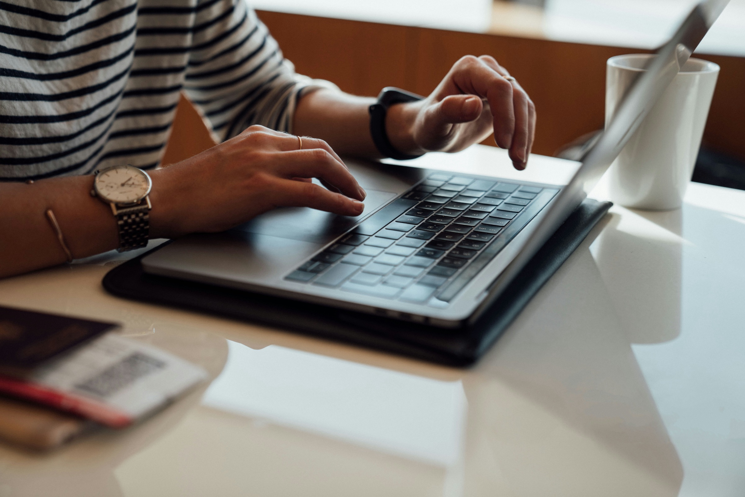 A person typing at a laptop