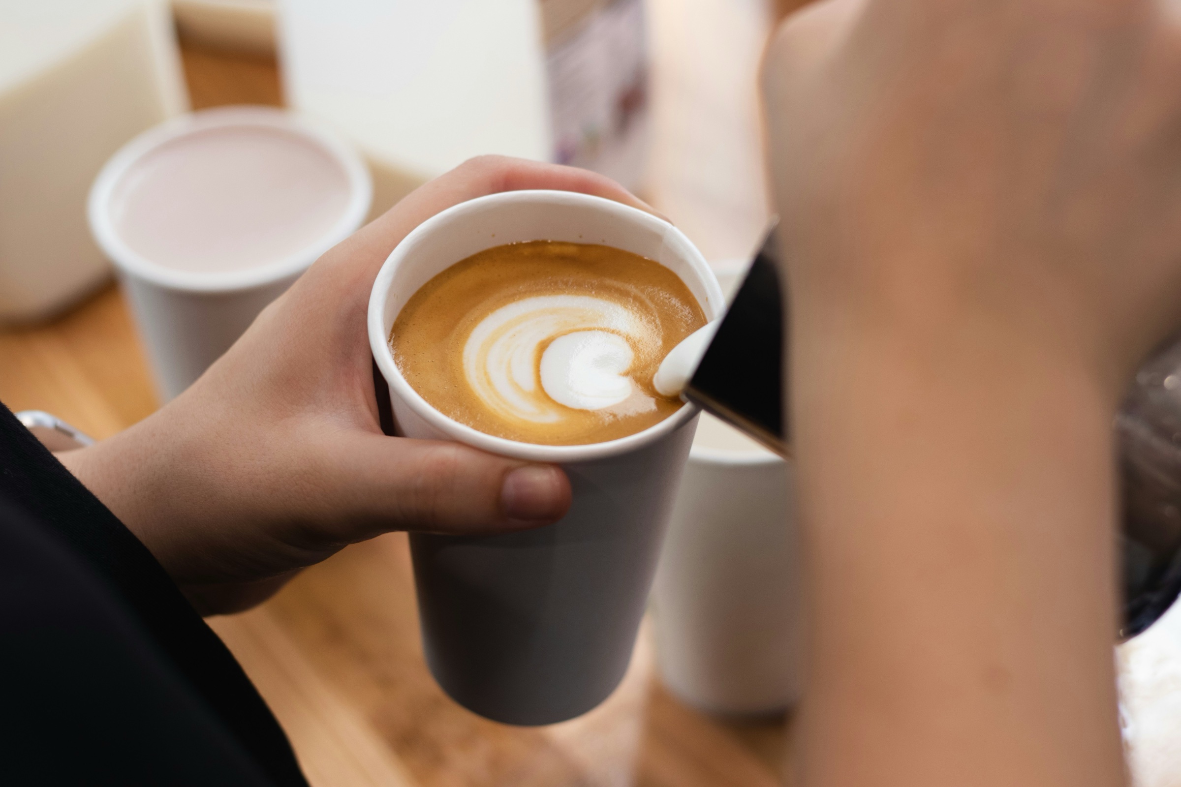 Someone pouring a coffee
